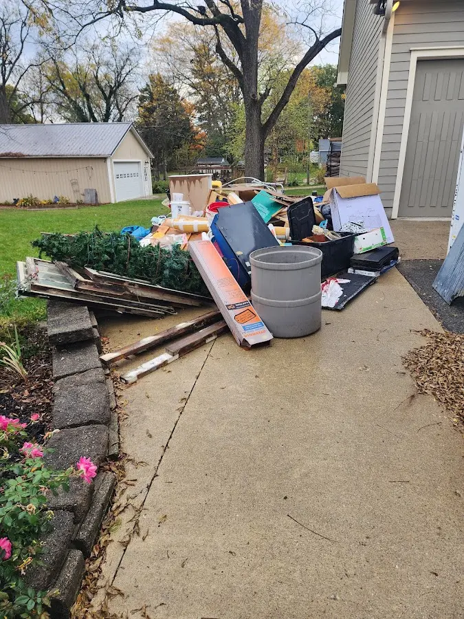 Dumpster being loaded with debris for 12 Yard Dumpster Rental in Oneida